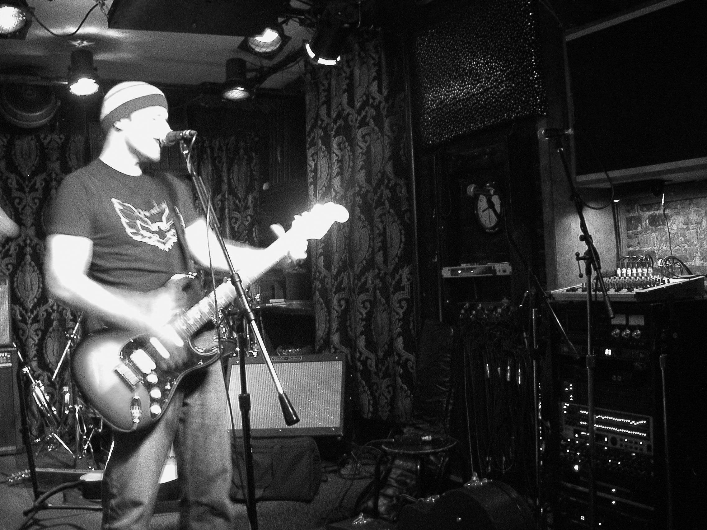 Vocalist on stage with dramatic backlight